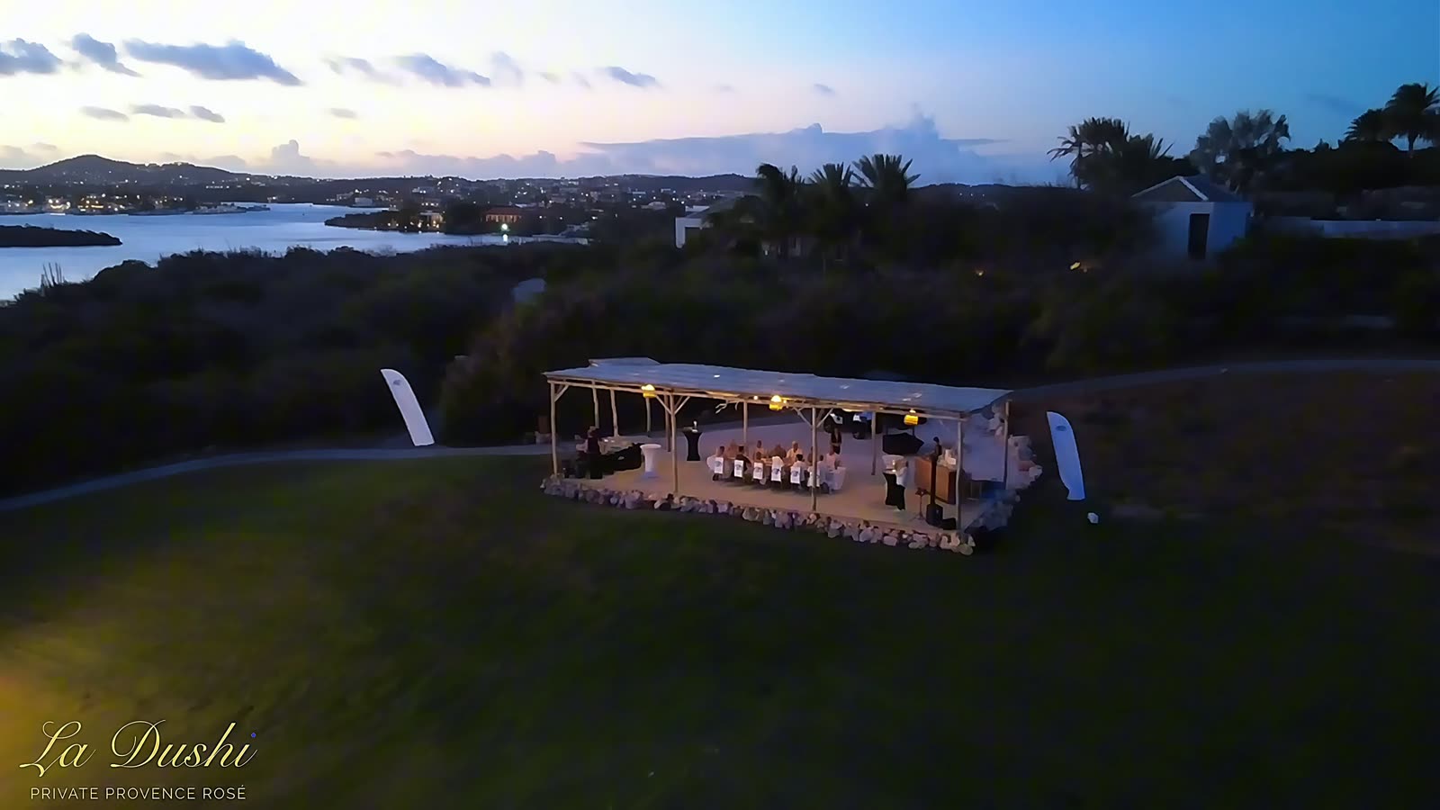 The setting seen from above at dusk, the sea beyond.
